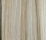Set of hair extensions in various colors on a textured surface